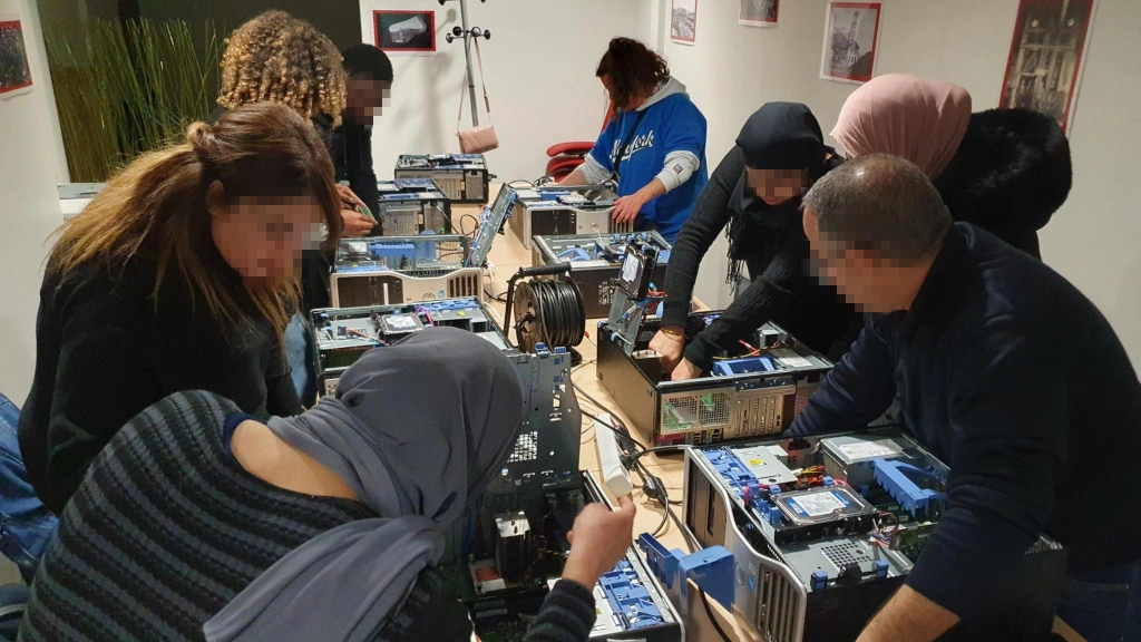atelier maintenance inofrmatique. Le groupe examine l'intérieur d'un ordinateur.